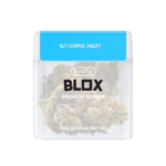 Tropic Haze cannabis flower featuring dense, frosty green buds with orange pistils and vibrant trichome coverage.