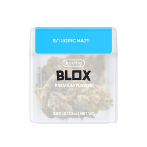 Tropic Haze cannabis flower featuring dense, frosty green buds with orange pistils and vibrant trichome coverage.